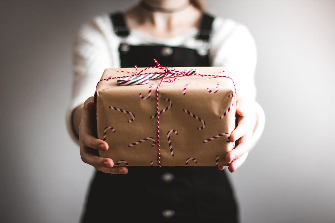 A person holding a wrapped gift